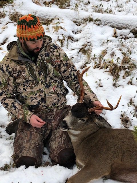 aaron dupuis with blacktail buck in snow
